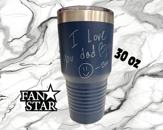 A blue tumbler with a handwritten message that says "I love you dad" and a smiley face drawn on it. The tumbler is placed on a marble background, and there is text indicating the size and weight of the item.